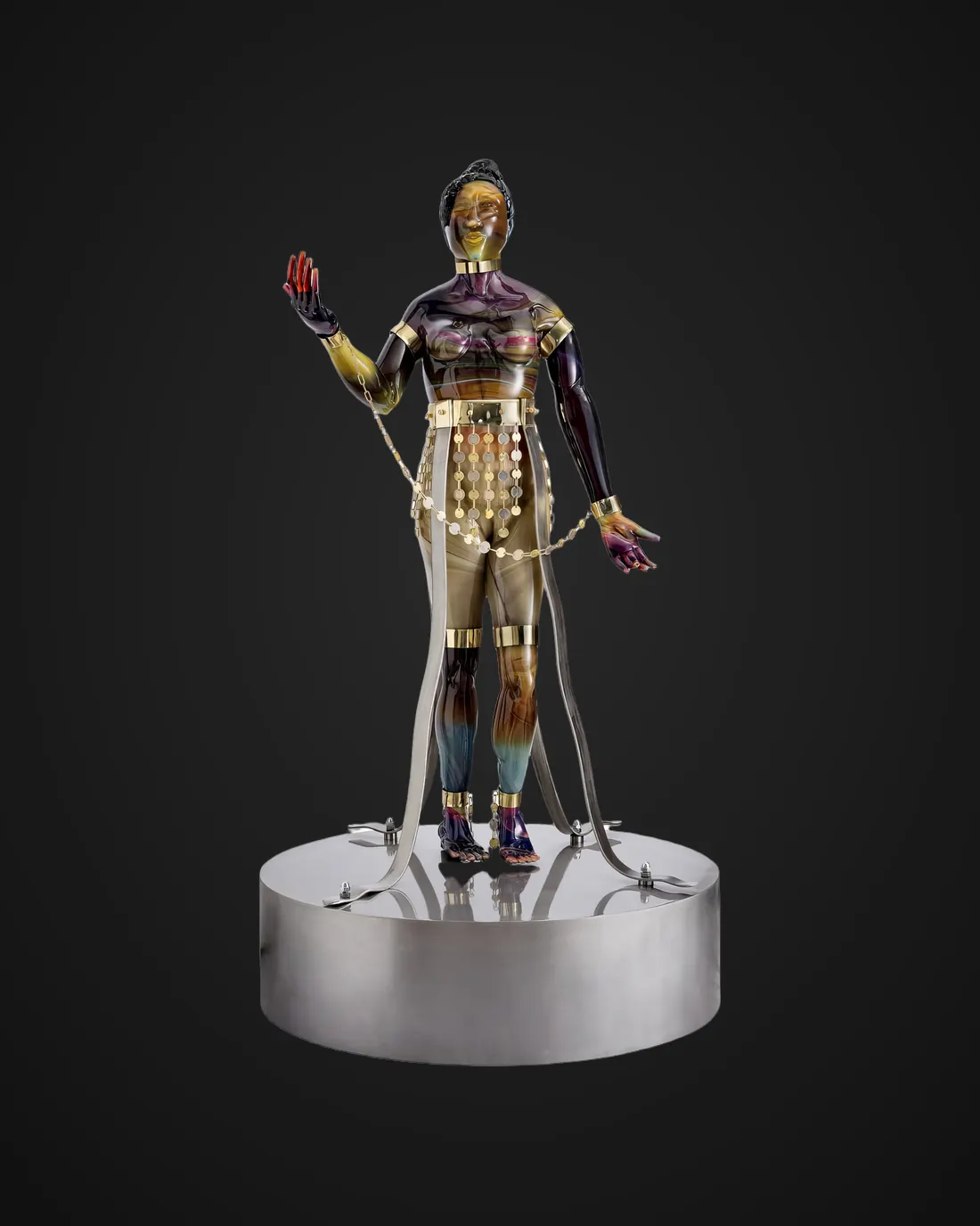 Glass and metal sculpture by Alexis Silk: golden figure on a base